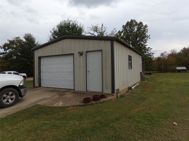 garage featuring a lawn