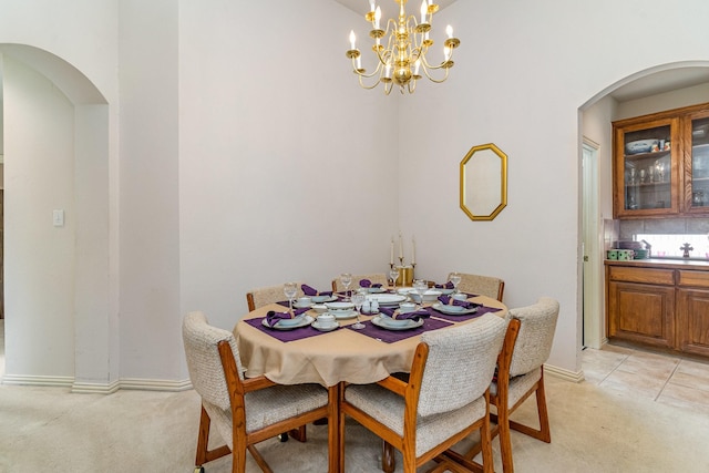 carpeted dining space with a chandelier