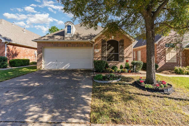 view of front of property with a garage and a front yard