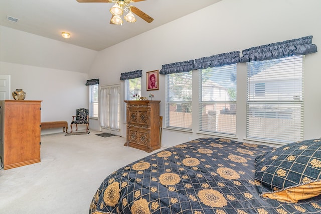 carpeted bedroom with multiple windows, lofted ceiling, and ceiling fan