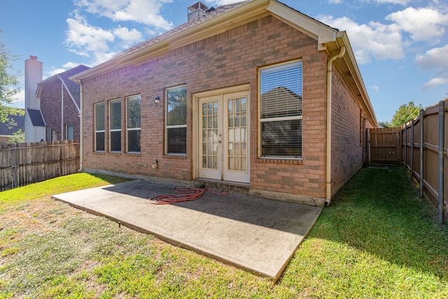 rear view of property featuring a patio and a lawn