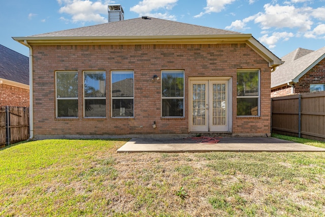 back of property featuring a patio and a lawn