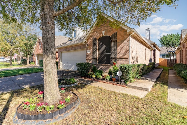 view of front of house with a garage and a front lawn