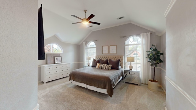 carpeted bedroom with ceiling fan, crown molding, and vaulted ceiling