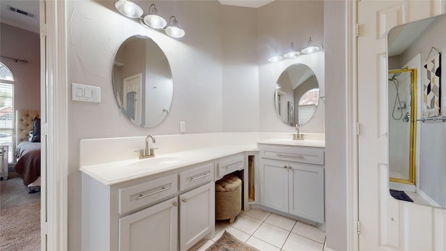 bathroom with tile patterned floors, vanity, and an enclosed shower