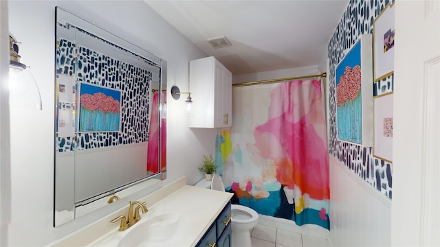 bathroom featuring tile patterned flooring, a shower with curtain, vanity, and toilet