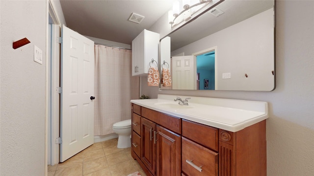 bathroom featuring tile patterned floors, vanity, and toilet