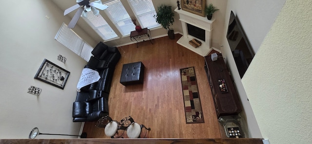 living room featuring ceiling fan and a high ceiling