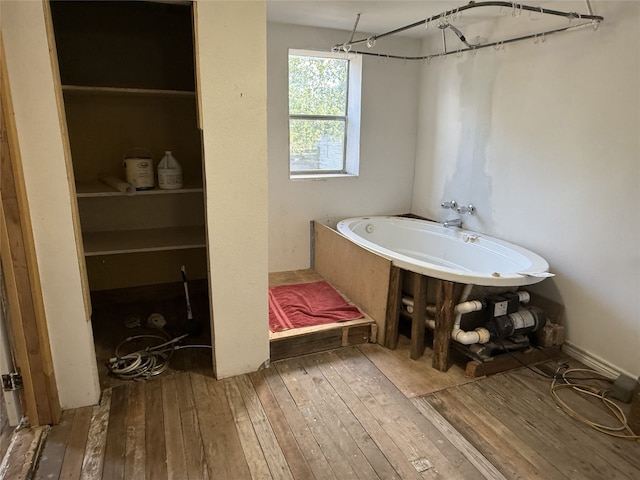 bathroom featuring shower with separate bathtub and hardwood / wood-style floors