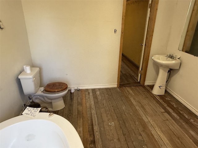 bathroom featuring toilet and hardwood / wood-style flooring