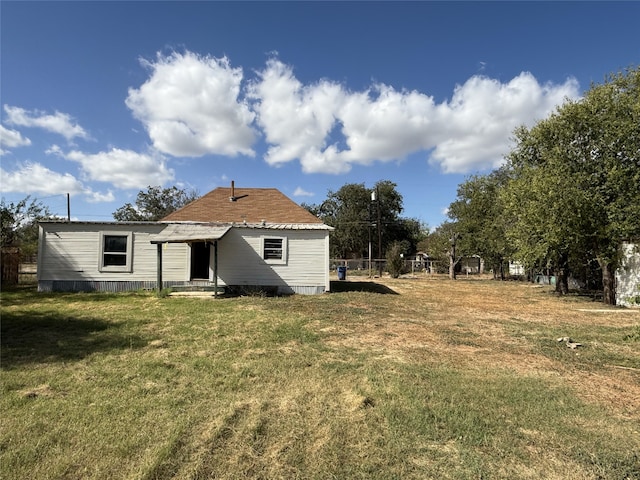 rear view of house with a lawn