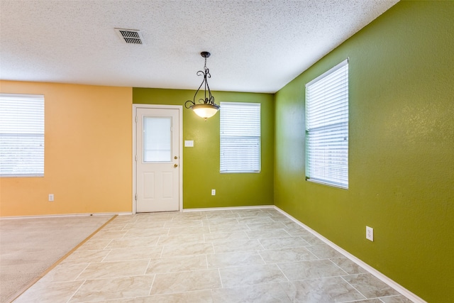 foyer entrance with a textured ceiling