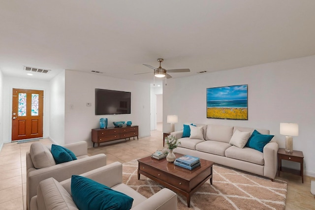 tiled living room with ceiling fan