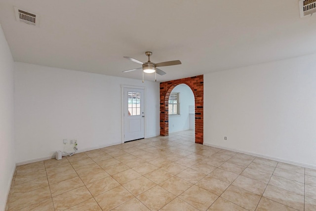 unfurnished room with light tile patterned floors and ceiling fan