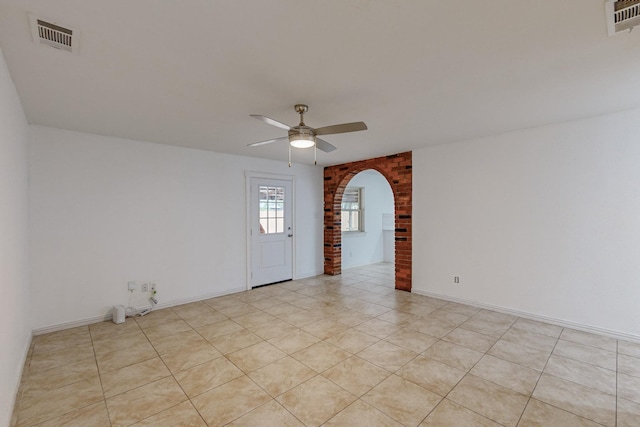 12304 Knight Dr, Balch Springs, TX 75180 - spare room with a ceiling fan, arched walkways, and light tile patterned floors