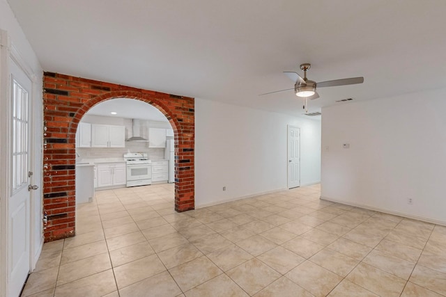 tiled empty room with ceiling fan