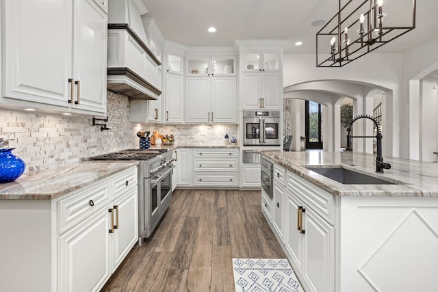 kitchen featuring sink, stainless steel appliances, custom exhaust hood, white cabinets, and dark wood-type flooring