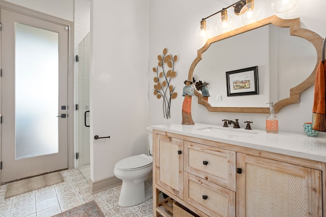 bathroom featuring vanity, toilet, a shower with shower door, and tile patterned flooring