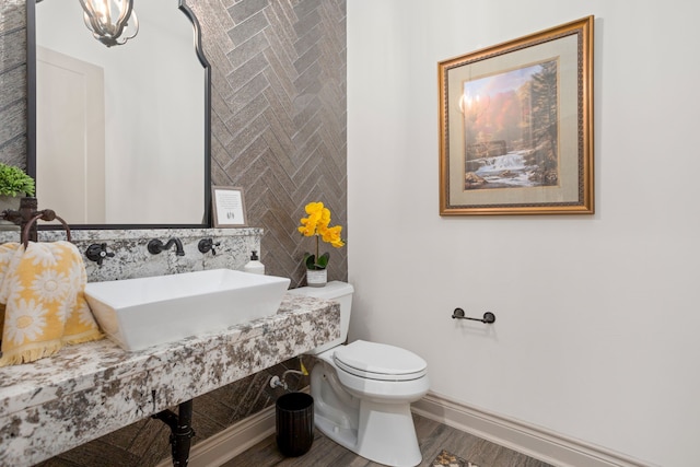 bathroom featuring sink, hardwood / wood-style flooring, and toilet