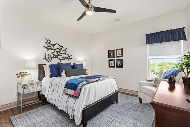 bedroom with dark hardwood / wood-style flooring and ceiling fan