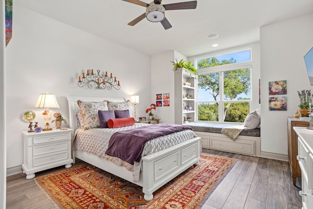 bedroom with ceiling fan and light wood-type flooring