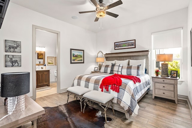 bedroom with light hardwood / wood-style flooring, ensuite bathroom, and ceiling fan