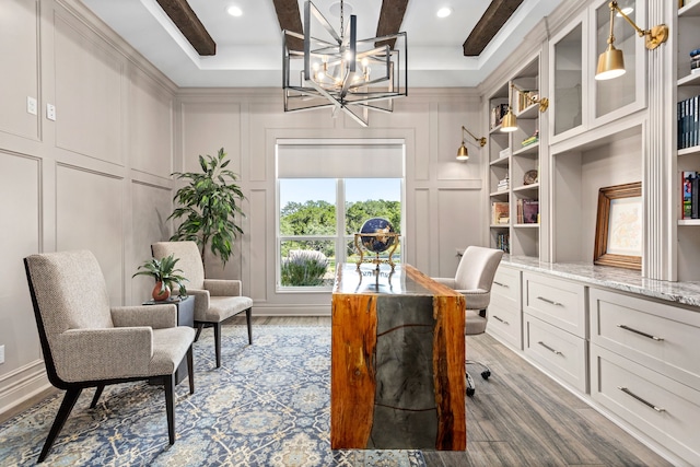 office space with hardwood / wood-style flooring, beamed ceiling, a tray ceiling, and a chandelier