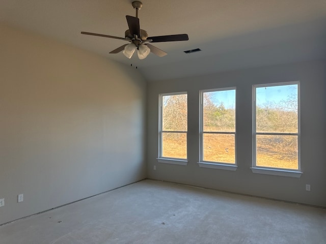 empty room with ceiling fan, a healthy amount of sunlight, and vaulted ceiling