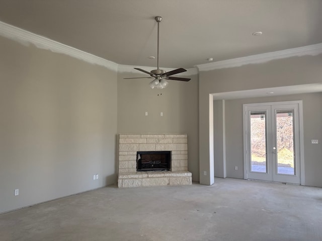 unfurnished living room with a fireplace, ceiling fan, french doors, and ornamental molding