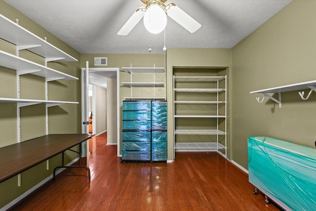 spacious closet featuring dark hardwood / wood-style flooring and ceiling fan