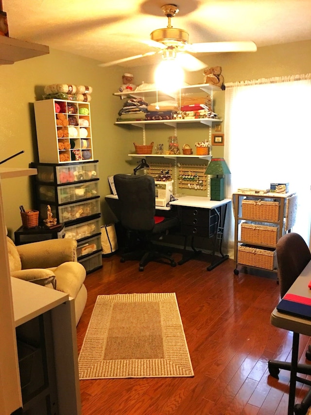 home office featuring a ceiling fan and dark wood finished floors