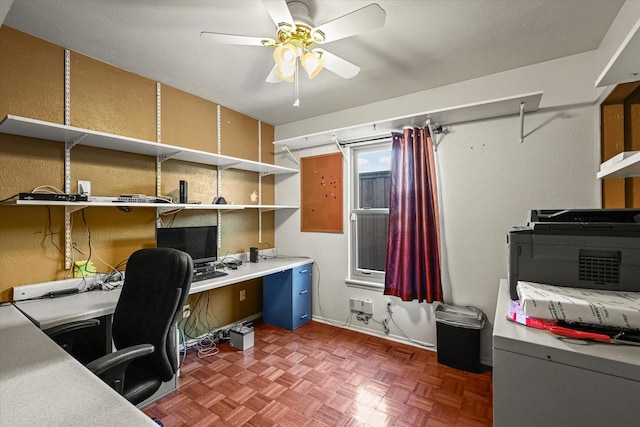 office space with dark parquet floors and ceiling fan