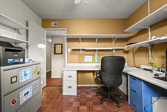 home office with dark parquet flooring