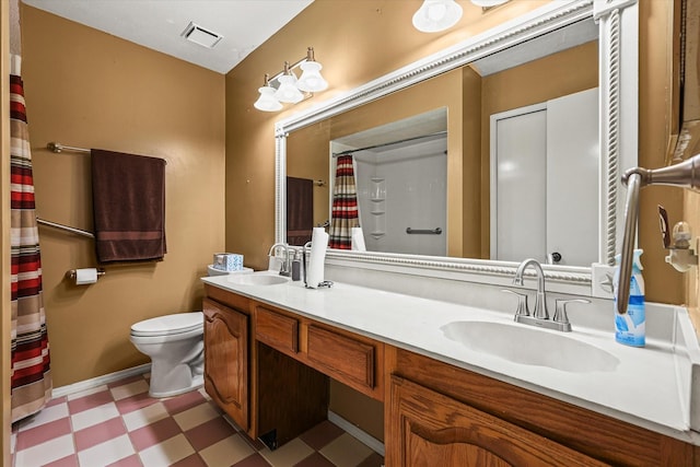 bathroom featuring double vanity, a sink, and tile patterned floors