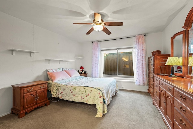 bedroom with a ceiling fan, light carpet, and baseboards