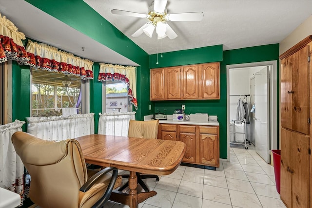 kitchen featuring a textured ceiling and ceiling fan