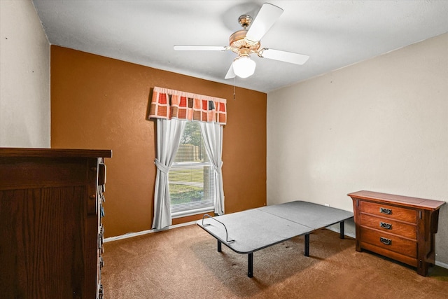 carpeted home office featuring ceiling fan