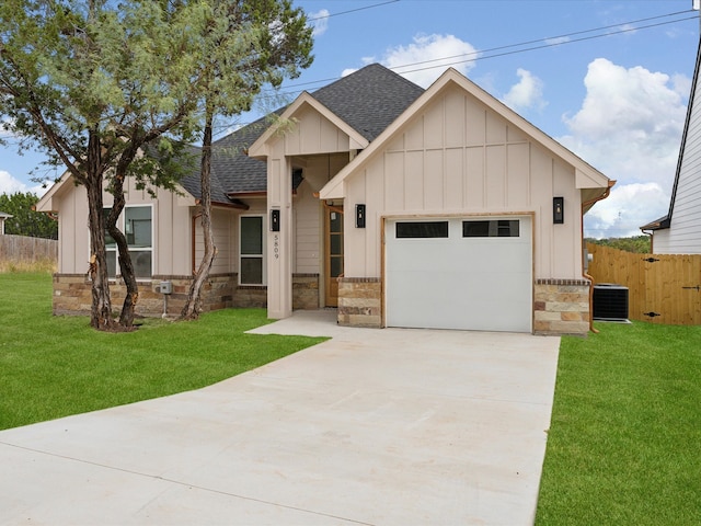 view of front facade featuring central AC unit, a garage, and a front lawn