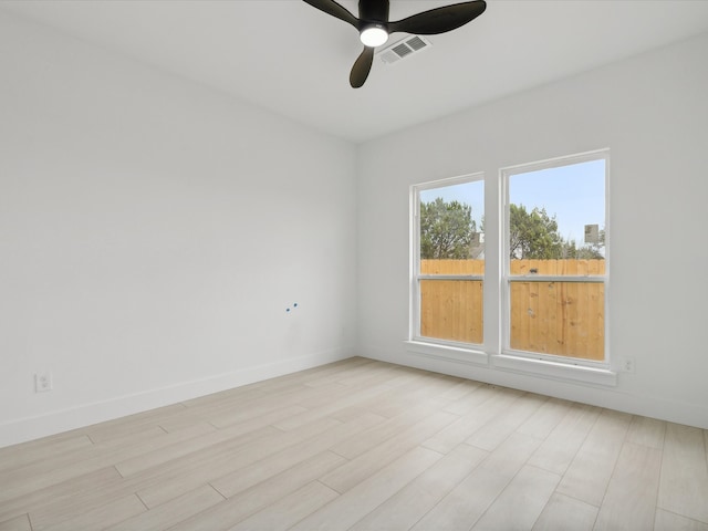 empty room featuring ceiling fan and light hardwood / wood-style floors