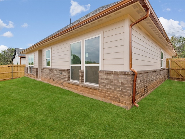 view of property exterior featuring a lawn