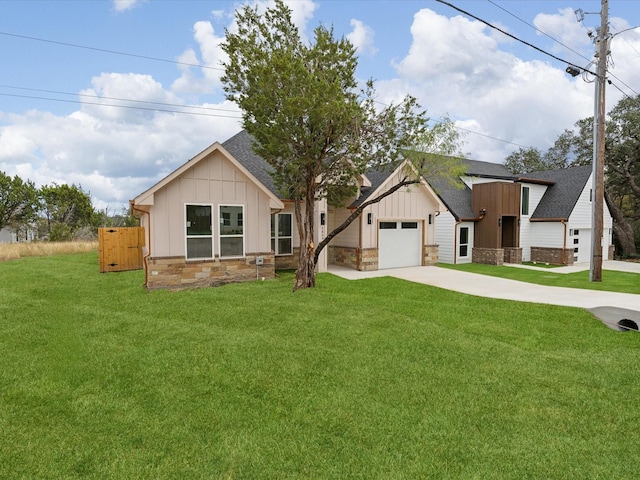 view of front of property with a front yard and a garage