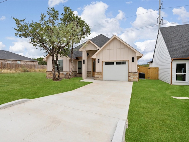 view of front facade featuring central AC, a garage, and a front lawn