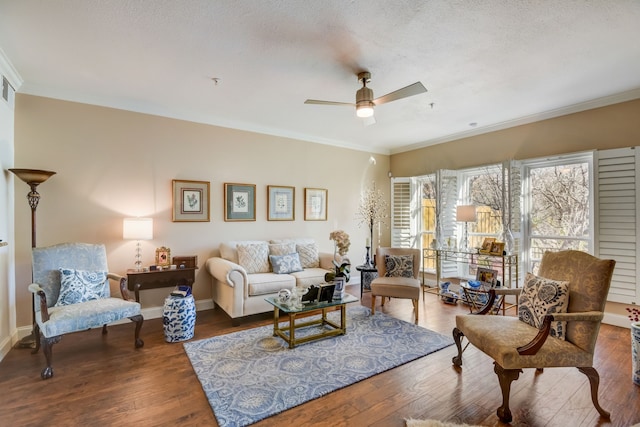 living room featuring a textured ceiling, wood-type flooring, ceiling fan, and crown molding