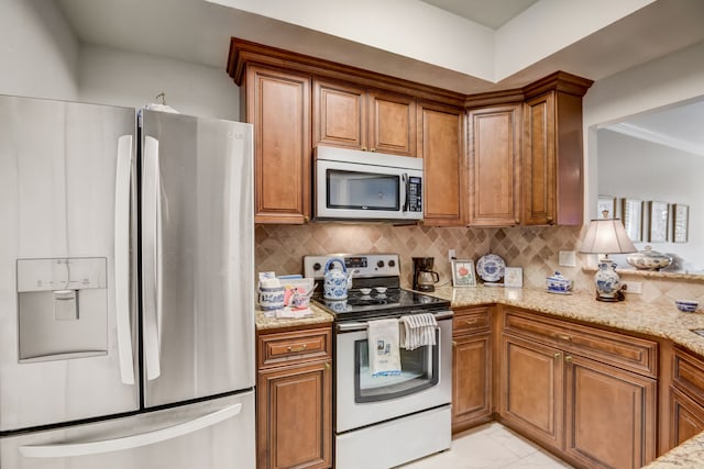 kitchen with light stone countertops, decorative backsplash, appliances with stainless steel finishes, and ornamental molding