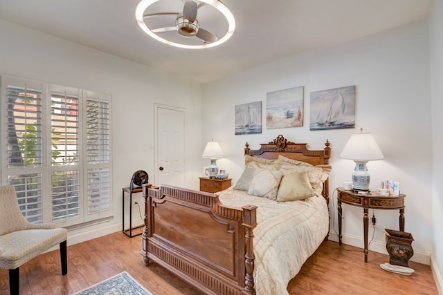 bedroom with light hardwood / wood-style floors and ceiling fan