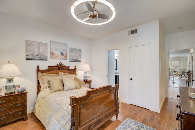 bedroom with light hardwood / wood-style floors and ceiling fan