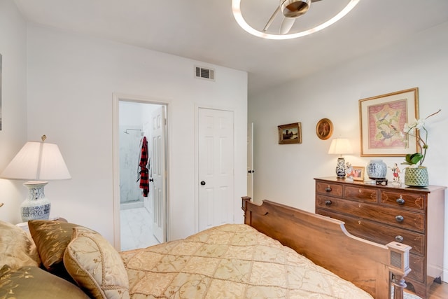 bedroom with ceiling fan and connected bathroom