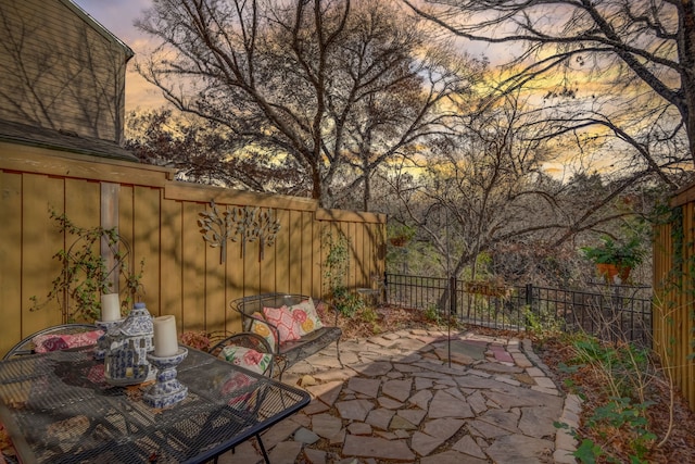 view of patio terrace at dusk