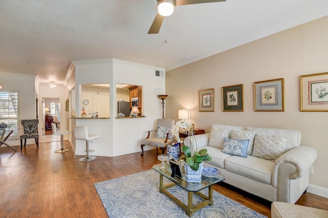 living room with ornamental molding, hardwood / wood-style floors, a textured ceiling, and ceiling fan