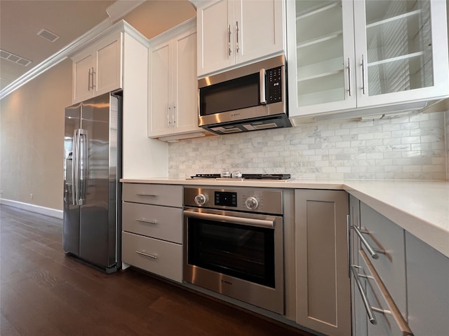 kitchen with tasteful backsplash, white cabinetry, dark hardwood / wood-style floors, gray cabinetry, and stainless steel appliances